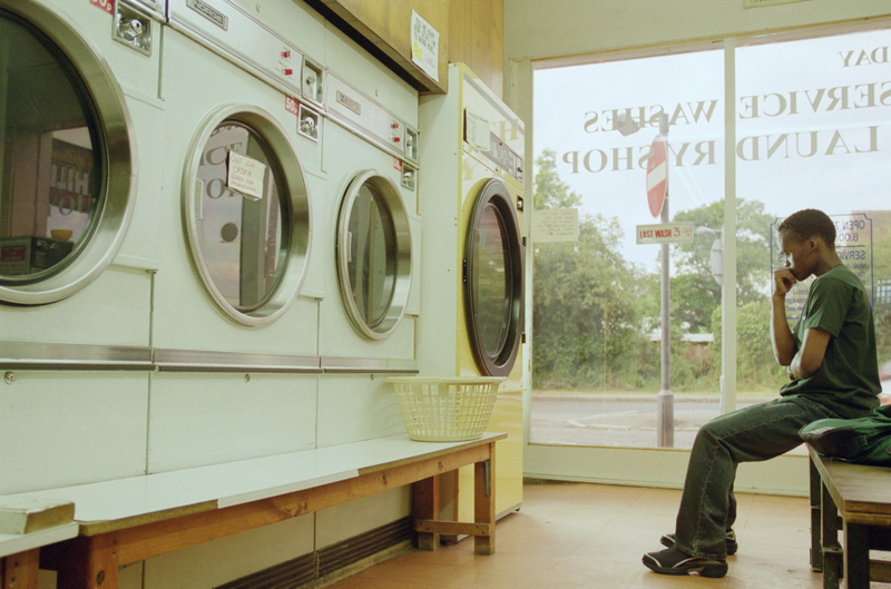 A guy doing laundry and almost certainly thinking about how bad doing laundry is. Photo credit: Jamie McDonald /Allsport/Getty